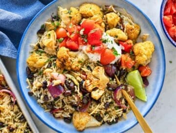 Step 4 Cauliflower Burrito Bowl served with Greek yogurt, tomatoes, lime, and cilantro.