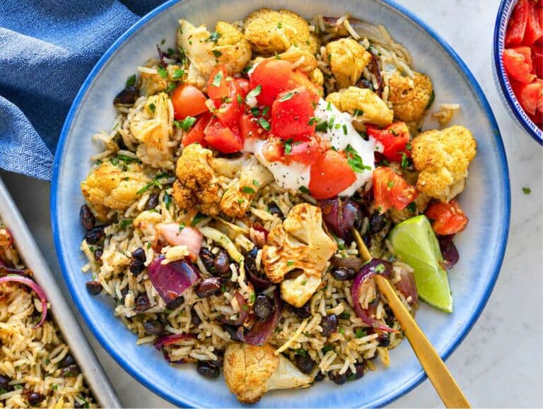 Step 4 Cauliflower Burrito Bowl served with Greek yogurt, tomatoes, lime, and cilantro.