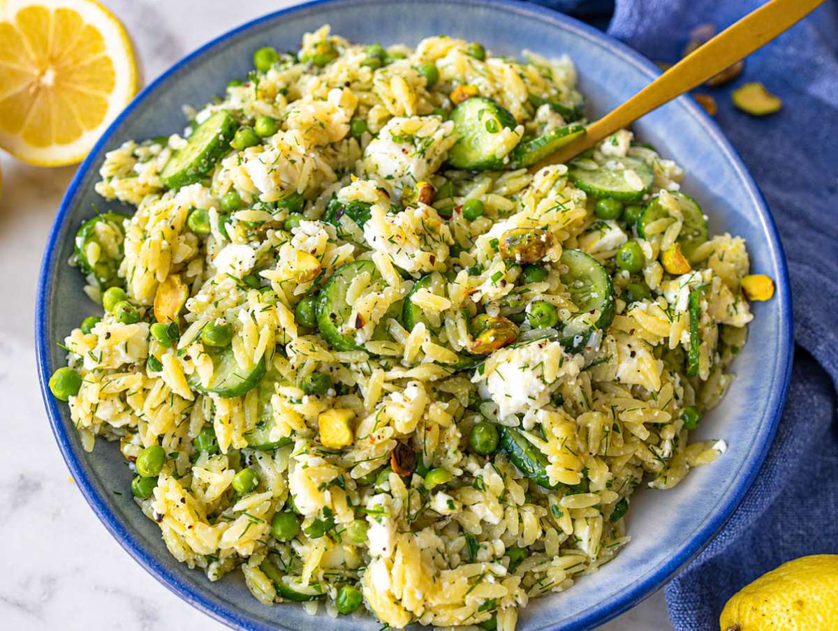 Step 4 Cucumber, herbs, and pistachios folded into cooled lemon orzo salad.