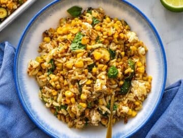 Step 4 Roasted corn orzo served warm with lime wedges and fresh basil garnish.