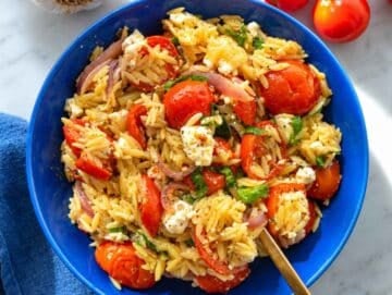 Step 4 Roasted tomato orzo garnished with basil, feta, black pepper, and olive oil.
