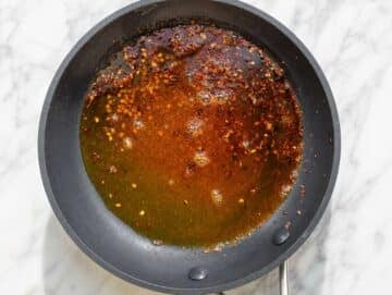 Step 4 Smoked paprika blooming in warm olive oil with chili flakes.