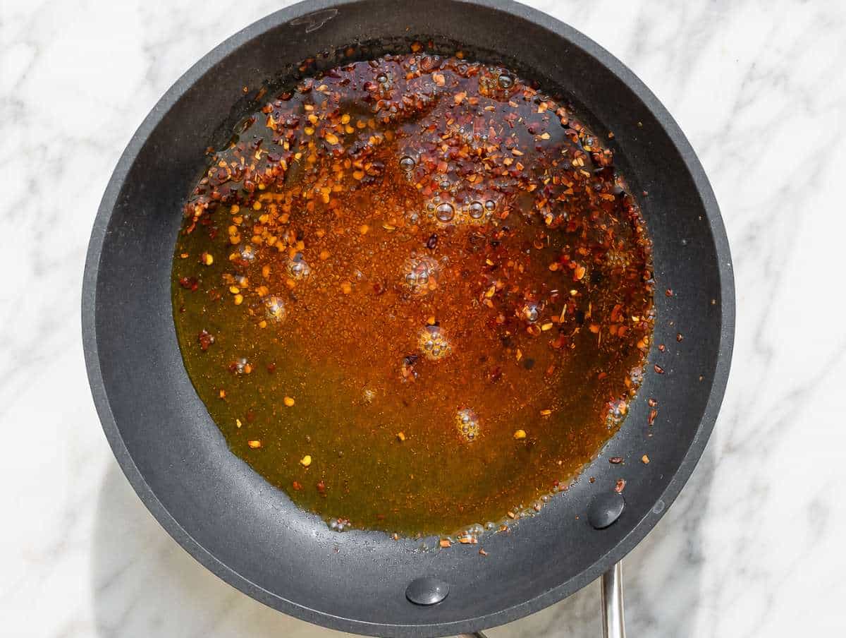 Step 4 Smoked paprika blooming in warm olive oil with chili flakes.