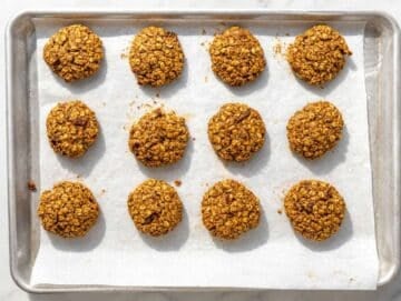 Step 5 Freshly baked Oatmeal Date Cookies cooling on a baking tray.