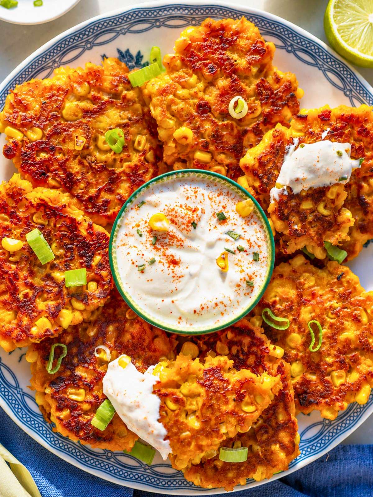 Sweet potato corn patties with Greek yogurt, lime, and green onion.