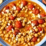 Tomato chickpea soup with crumbled feta in natural daylight.