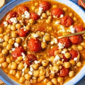 Tomato chickpea soup with crumbled feta in natural daylight.