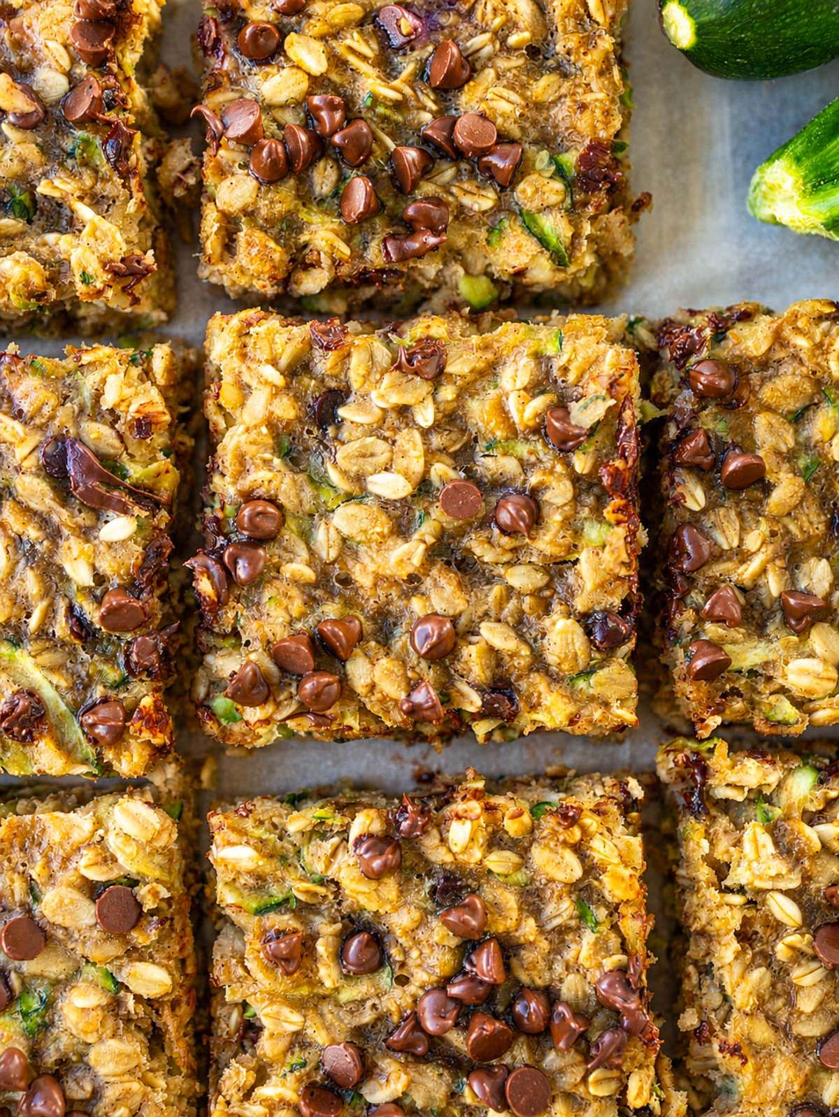 Zucchini banana bars with visible oats, zucchini, and melted chocolate chips.
