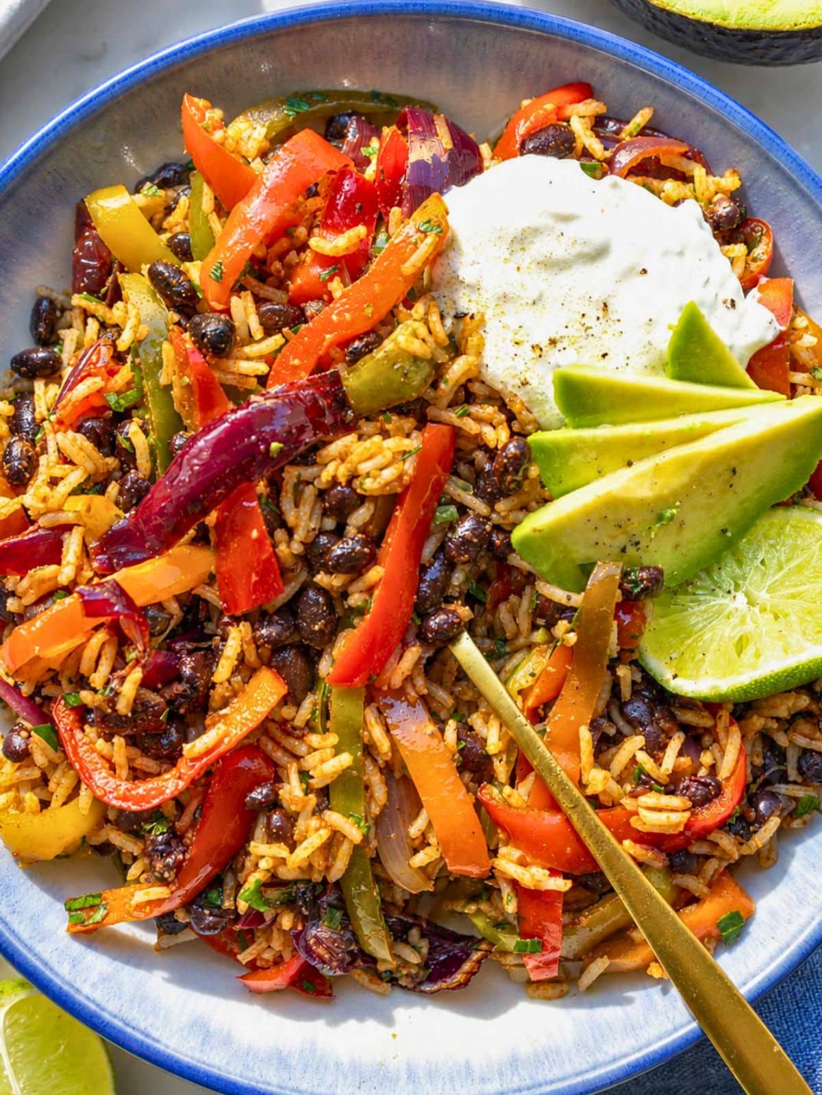 Black bean fajita bowl with avocado, yogurt, cilantro, and lime.