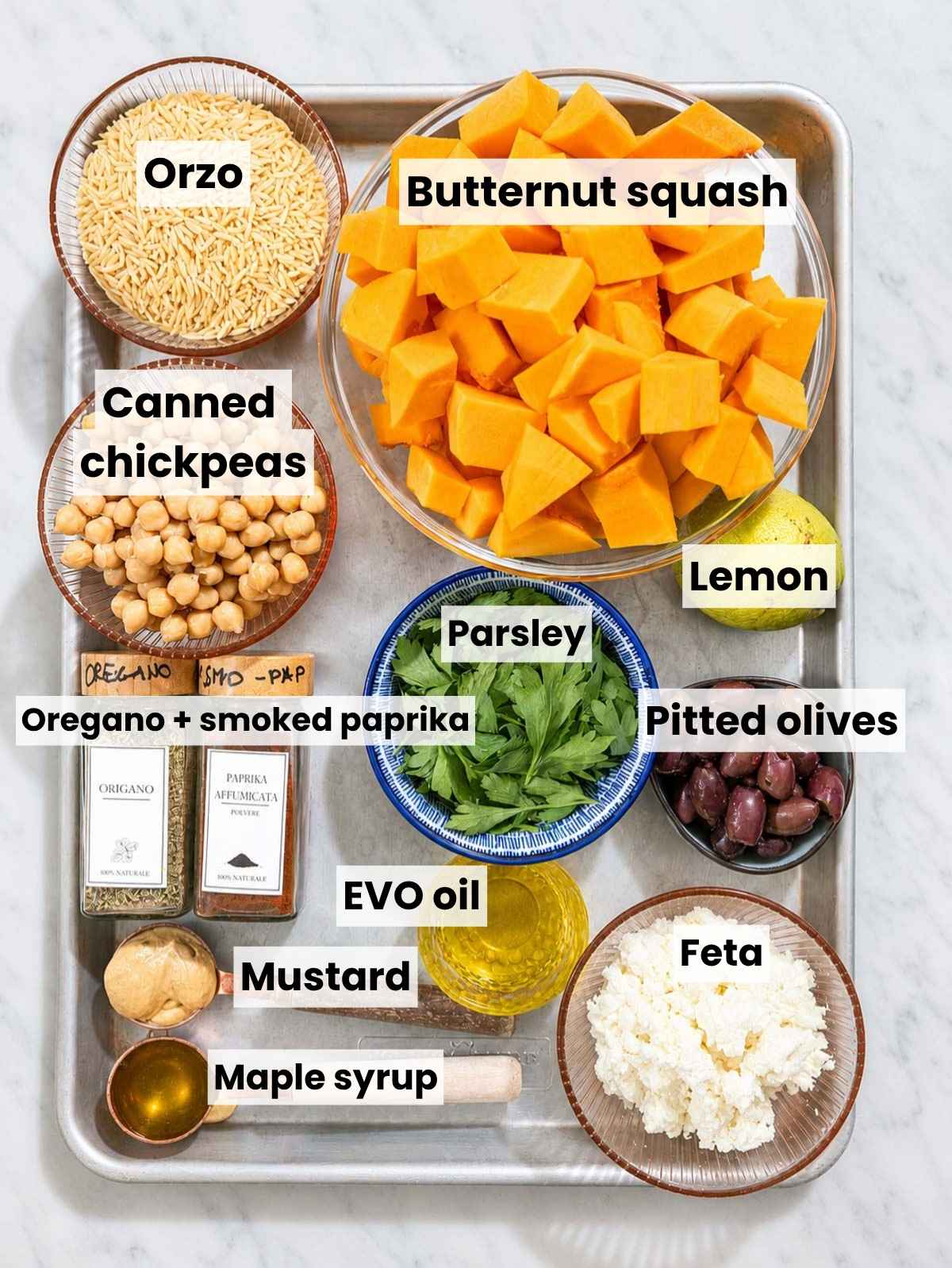 Butternut squash, chickpeas, orzo, feta, olives, lemon, herbs, and seasonings.