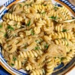 Caramelized onion pasta with creamy fusilli, golden onions, parsley, and pepper.