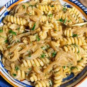 Caramelized onion pasta with creamy fusilli, golden onions, parsley, and pepper.