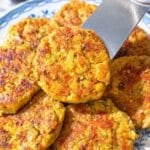 Chickpea potato patties with fresh lemon on a blue plate.