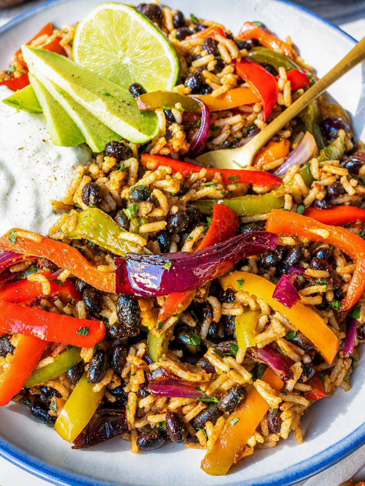 Close-up of black bean fajita bowl with roasted vegetables and rice.