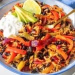 Colorful black bean fajita bowl with avocado in natural light.