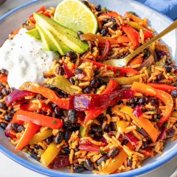 Colorful black bean fajita bowl with avocado in natural light.