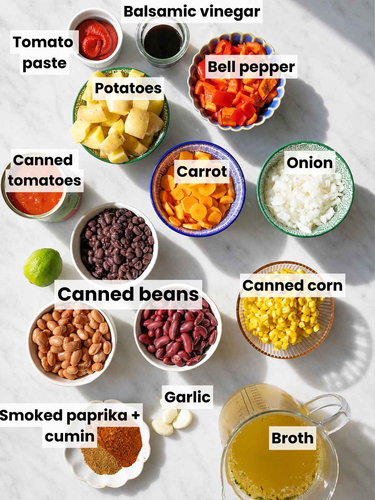 Cowboy Bean Soup ingredients arranged on marble in soft natural light.