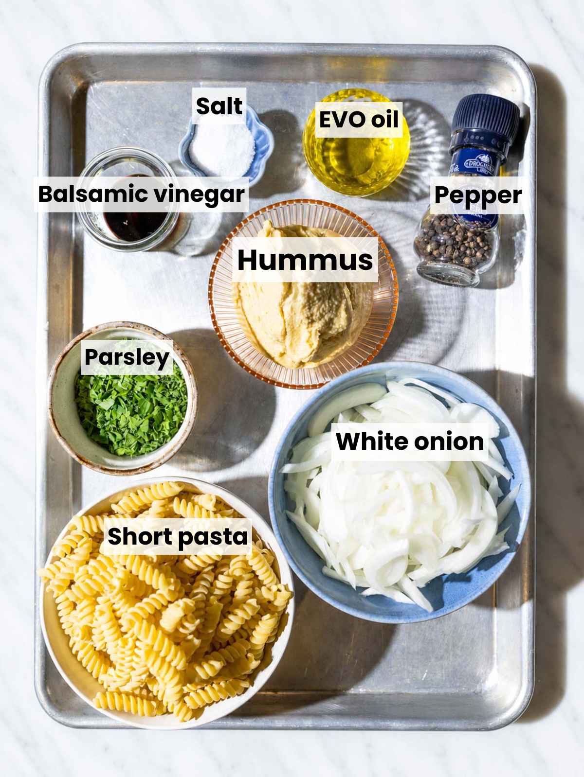 Fusilli, onions, hummus, balsamic vinegar, olive oil, parsley, and seasonings.
