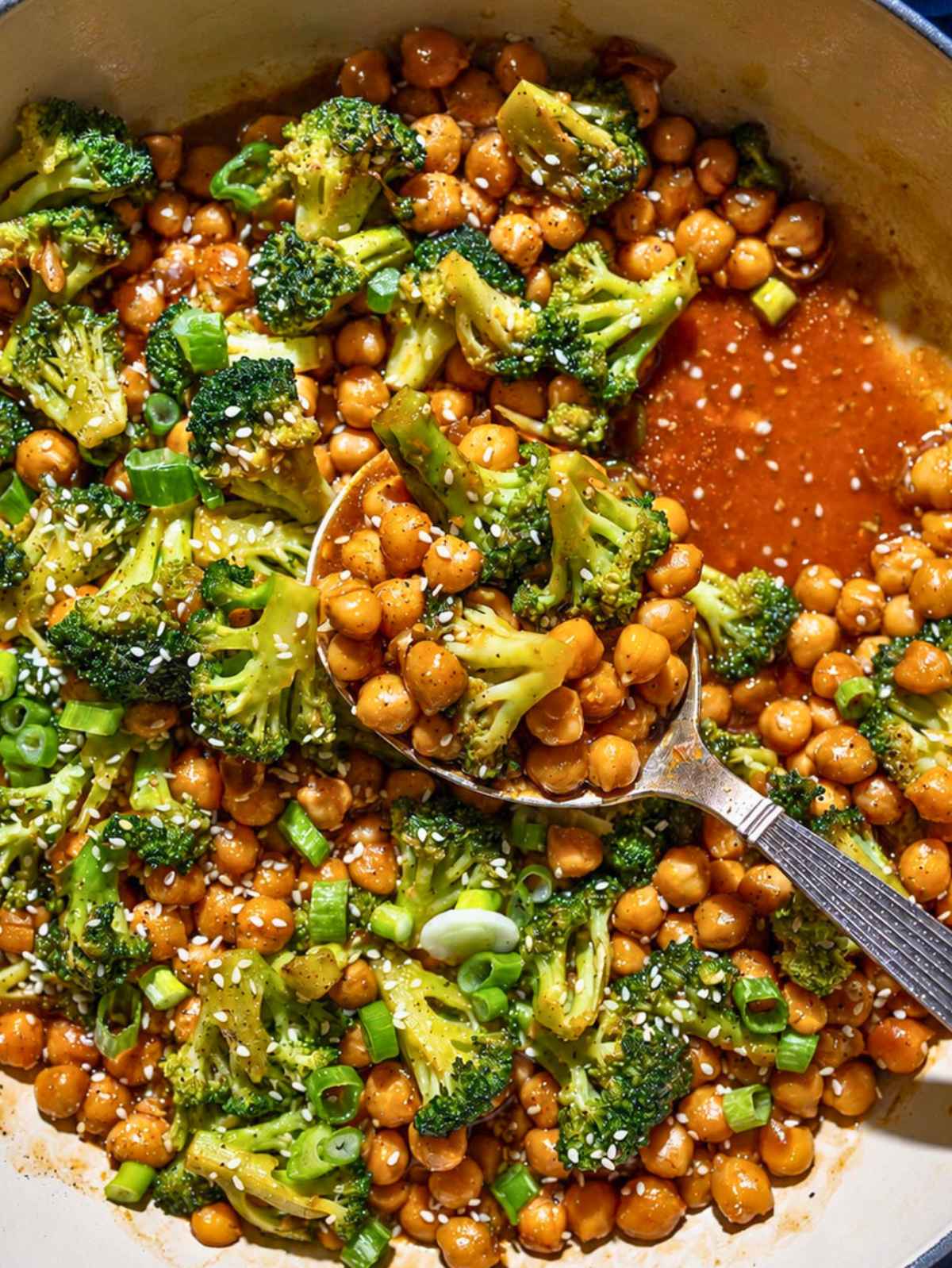 Sesame chickpeas and broccoli stir fry glistening in natural light.