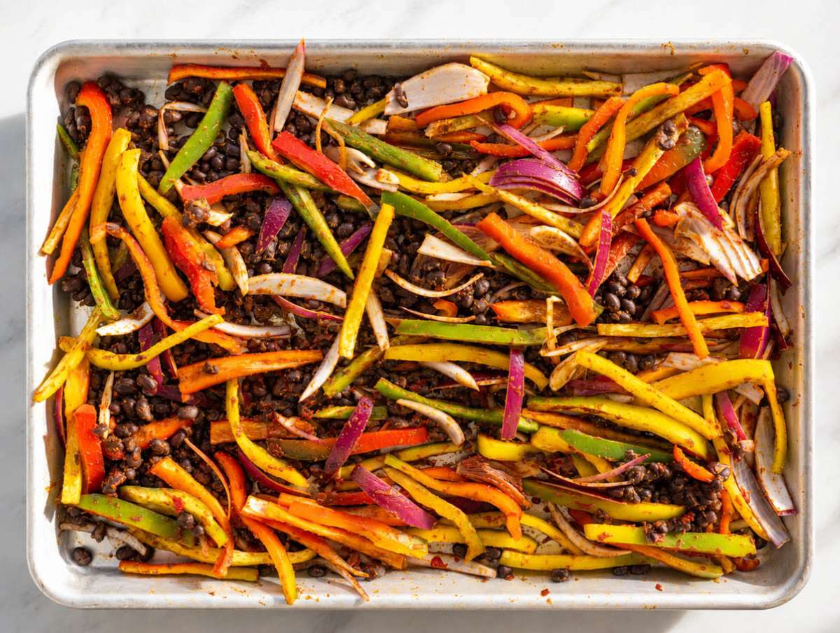 Step 1 Black beans, peppers, onions, spices, and tomato paste tossed on sheet pan.