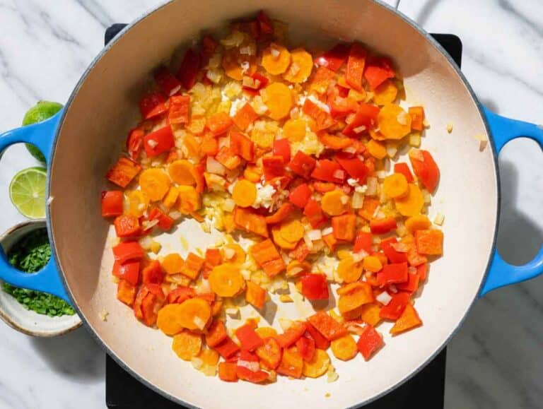 Step 1 Onion, bell pepper, and carrots sauteฬing in olive oil until softened.