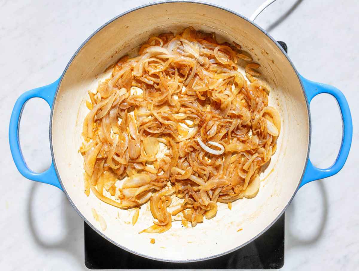 Step 1 Sliced onions cooking until deeply golden and jammy with balsamic vinegar.