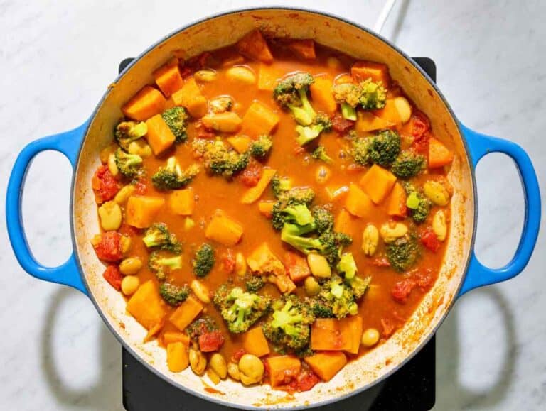 Step 2 Butter beans, diced sweet potatoes, tomatoes, and broccoli simmering together in the spiced curry sauce.