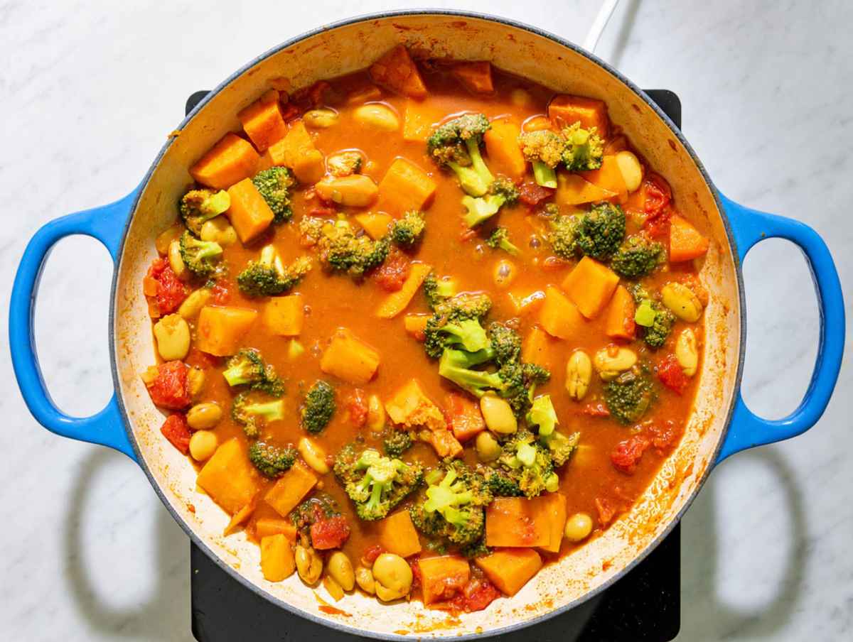 Step 2 Butter beans, diced sweet potatoes, tomatoes, and broccoli simmering together in the spiced curry sauce.