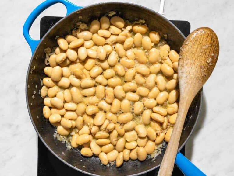 Step 2 Butter beans simmering with white wine, salt, and black pepper.