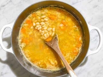 Step 2 Cannellini beans simmering in vegetable broth with tender vegetables.