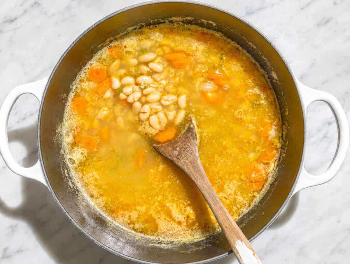 Step 2 Cannellini beans simmering in vegetable broth with tender vegetables.