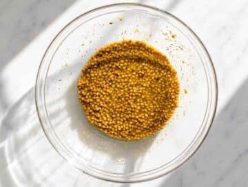 Step 3 Drained lentils marinating in oregano vinaigrette in a large mixing bowl.
