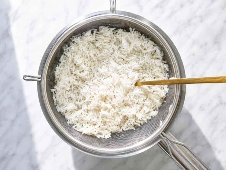 Step 3 Fluffy basmati rice draining in a fine-mesh strainer after cooking.