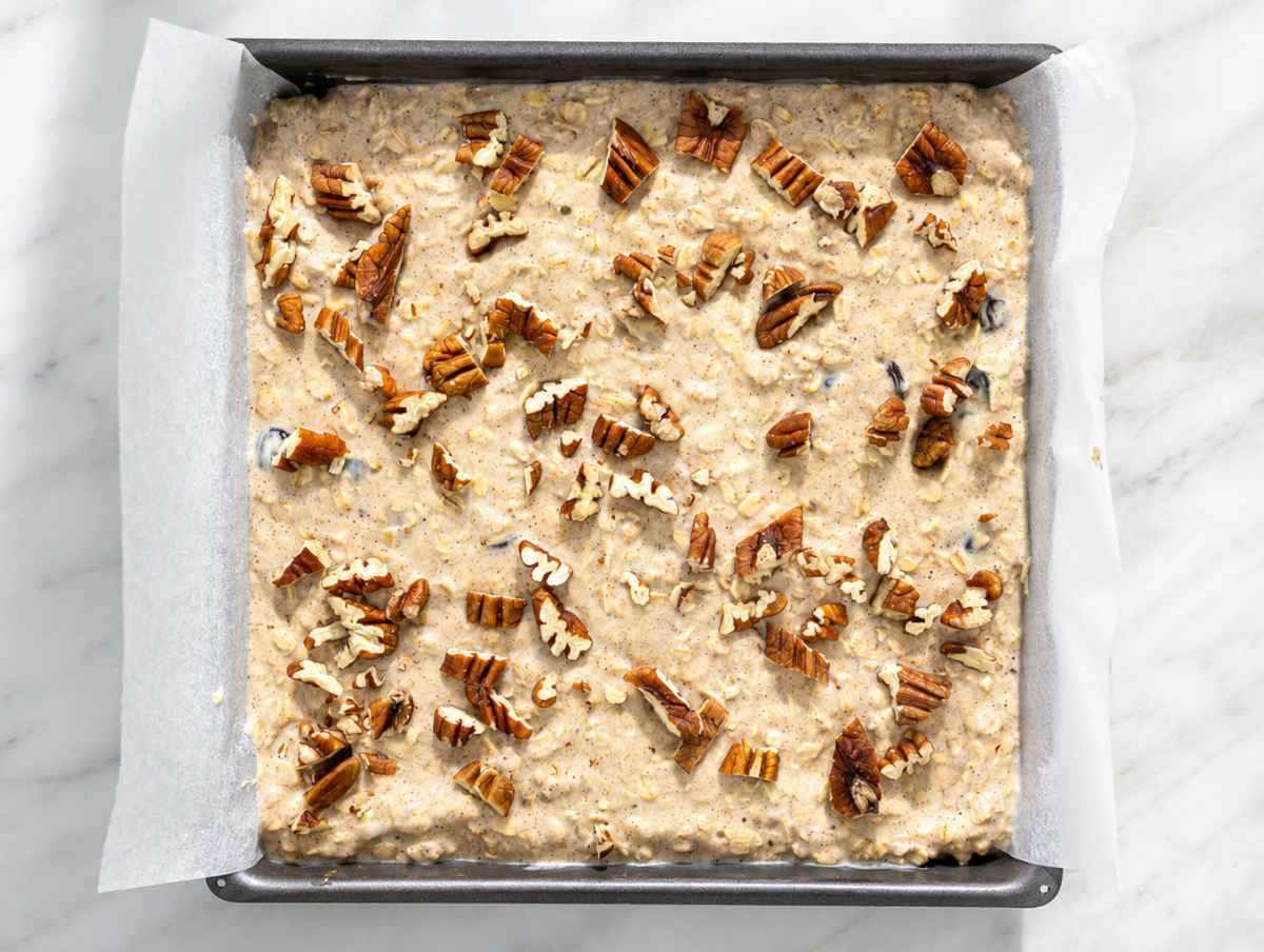 Step 3 Oat mixture folded with raisins, poured into baking dish, topped with pecans.