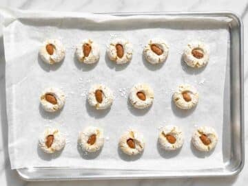 Step 3 Whole almonds pressed into sugar-coated dough balls before baking.