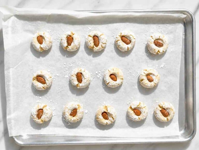 Step 3 Whole almonds pressed into sugar-coated dough balls before baking.