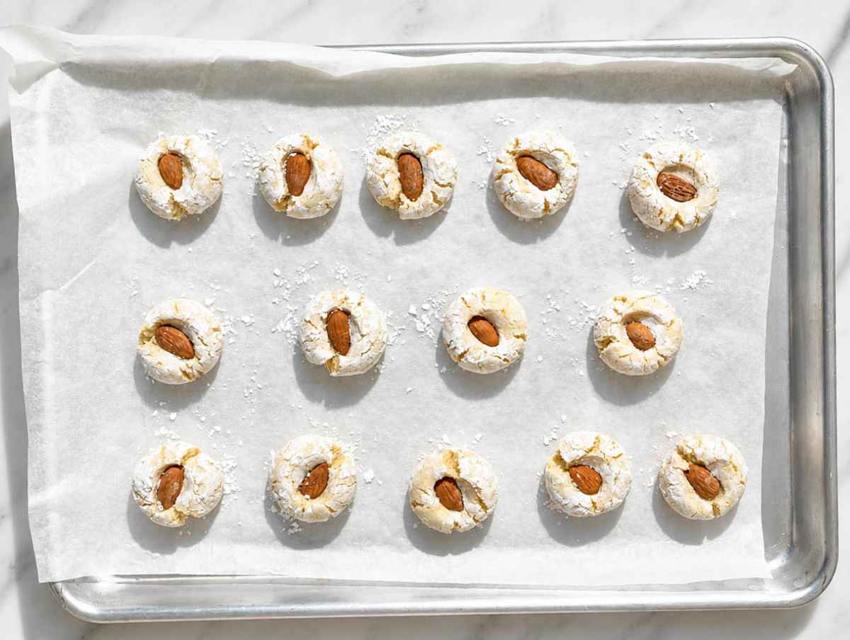 Step 3 Whole almonds pressed into sugar-coated dough balls before baking.