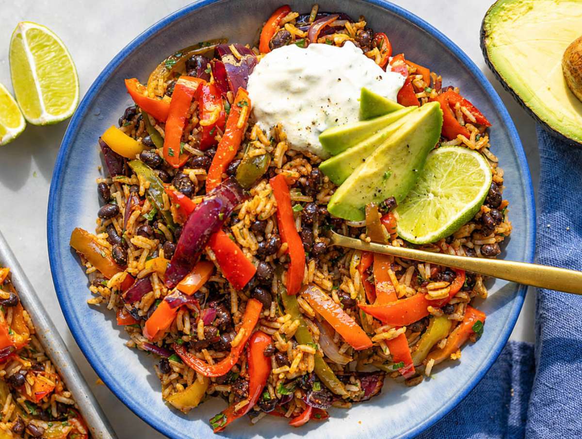 Step 4 Black bean fajita bowl topped with avocado, yogurt, and fresh cilantro.