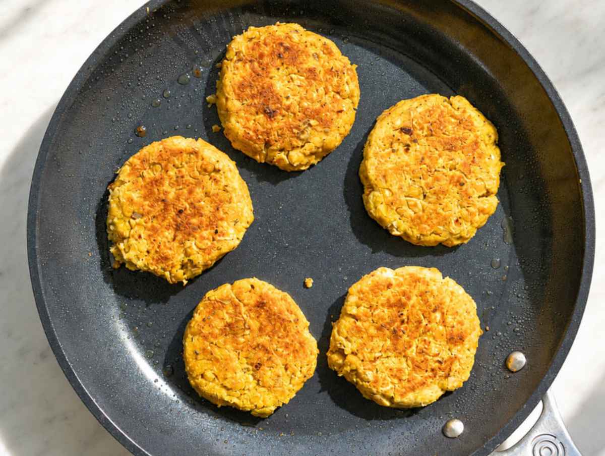 Step 4 Chickpea potato patties pan-frying in olive oil until deeply golden on both sides.
