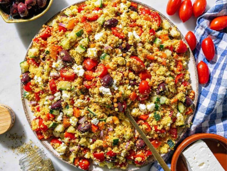 Step 4 Couscous, marinated lentils, chopped vegetables, olives, and feta tossed together.