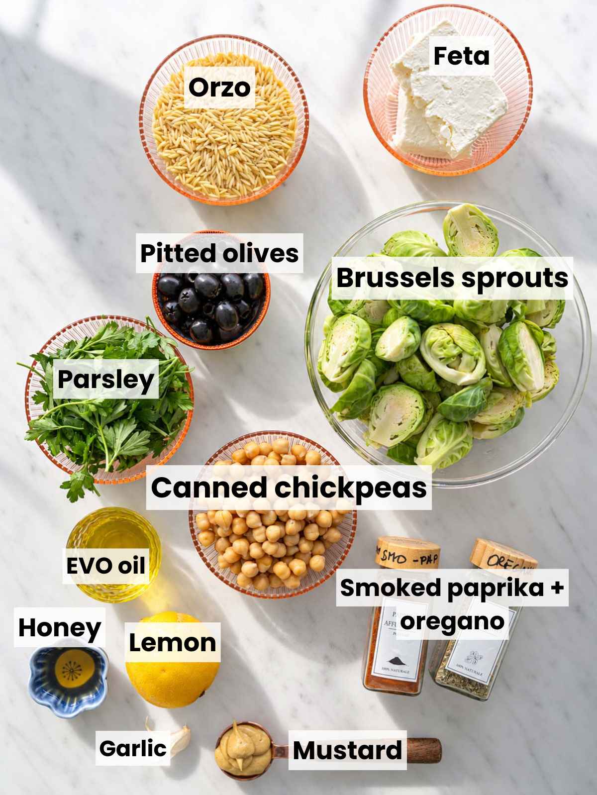 Brussels sprouts, chickpeas, orzo, feta, olives, lemon, herbs, and dressing ingredients.