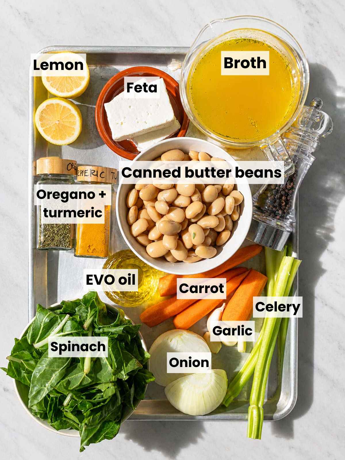 Butter bean soup ingredients arranged on marble in natural window light