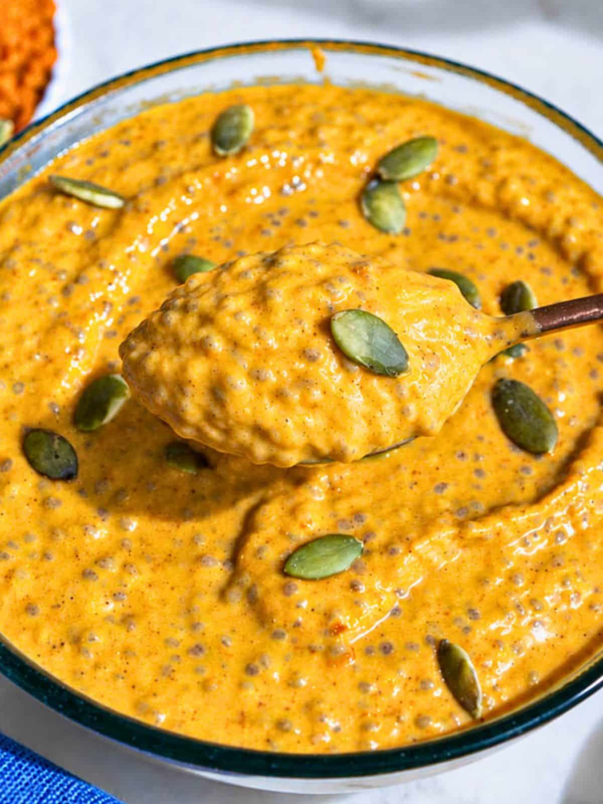 Close-up of creamy pumpkin chia pudding with pumpkin seeds.