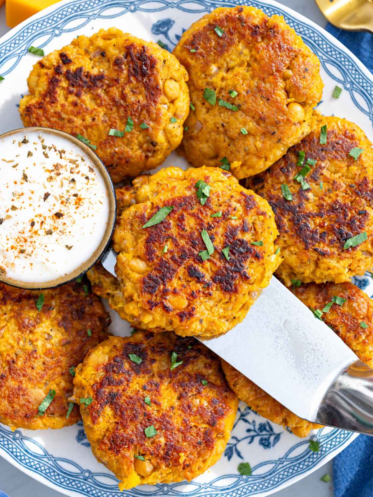 Close-up of crisp patties showing tender chickpea and butternut squash filling.