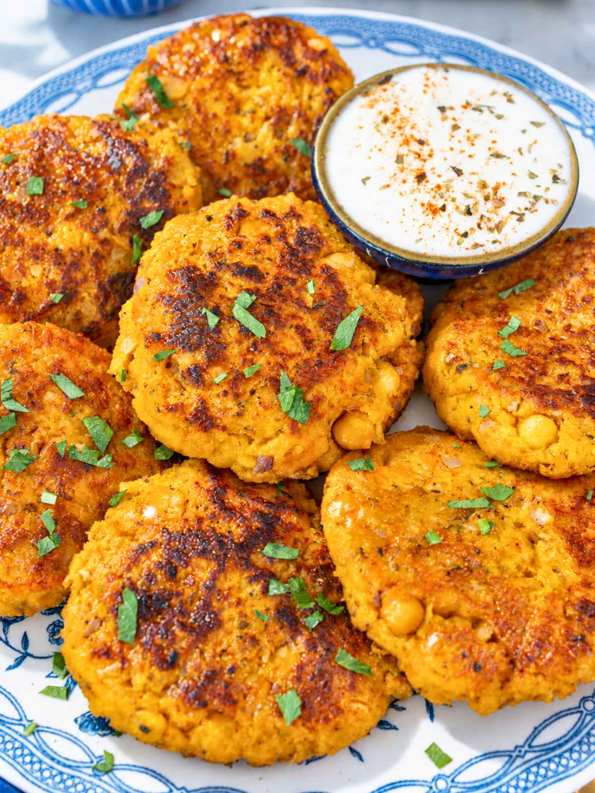 Crisp patties showing tender chickpea chunks and butternut squash filling.