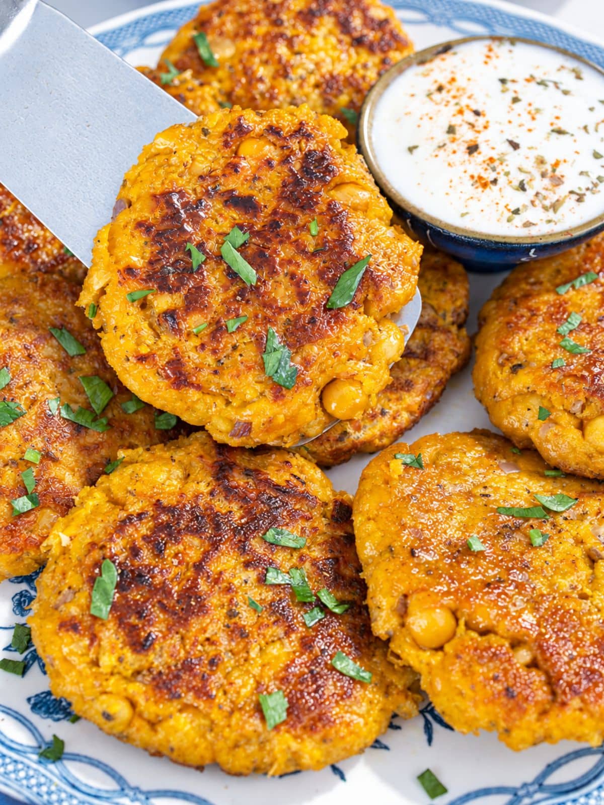 Golden Chickpea Butternut Squash Patties served with creamy dipping sauce.