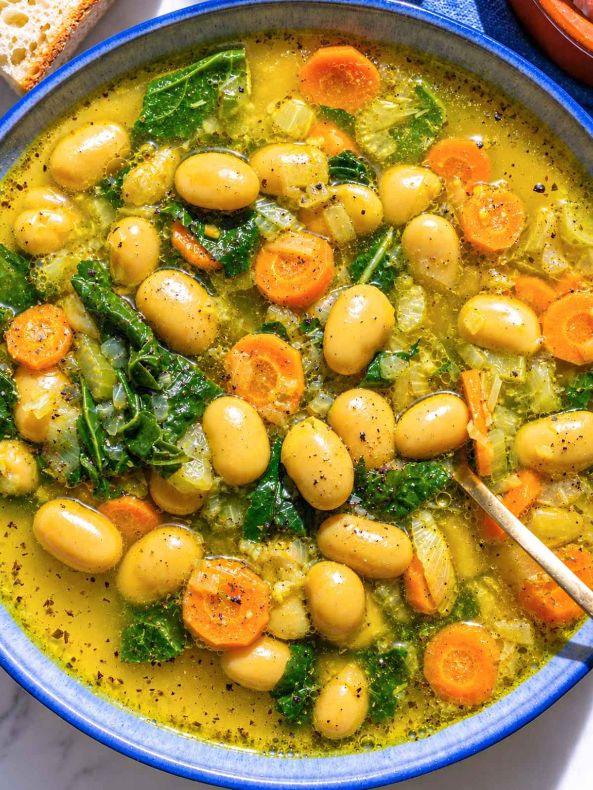 Lemon butter bean soup with spinach, pepper, and olive oil