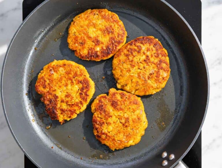 Step 4 Chickpea Butternut Squash Patties cooked in a skillet until golden and crisp.