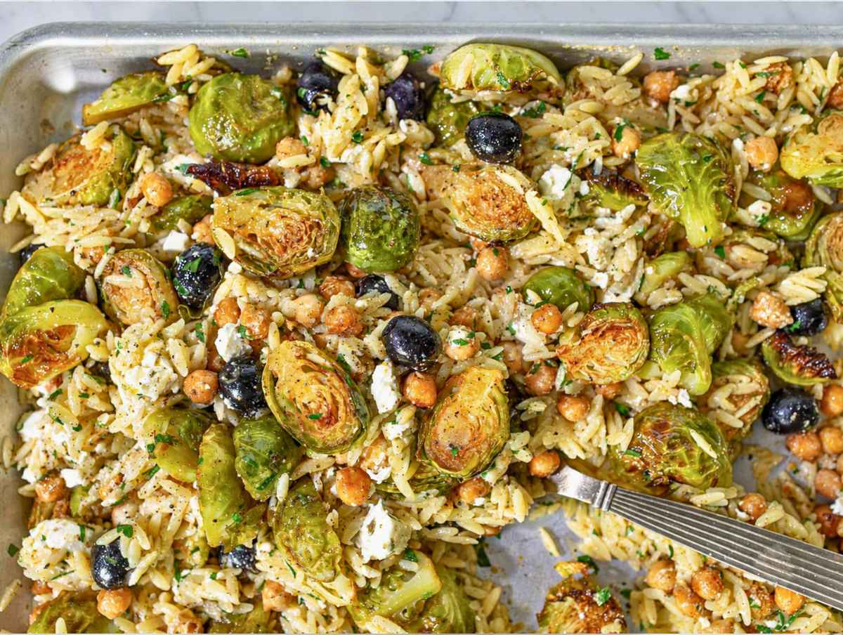 Step 4 Orzo tossed with roasted Brussels sprouts, chickpeas, feta, olives, and parsley.