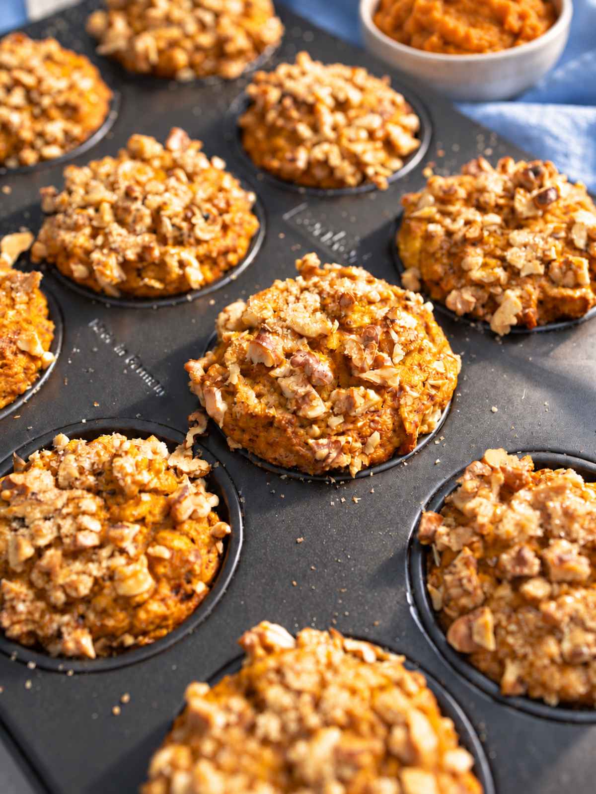 45 degree angle of pumpkin muffins showing its moist crumb and oats.